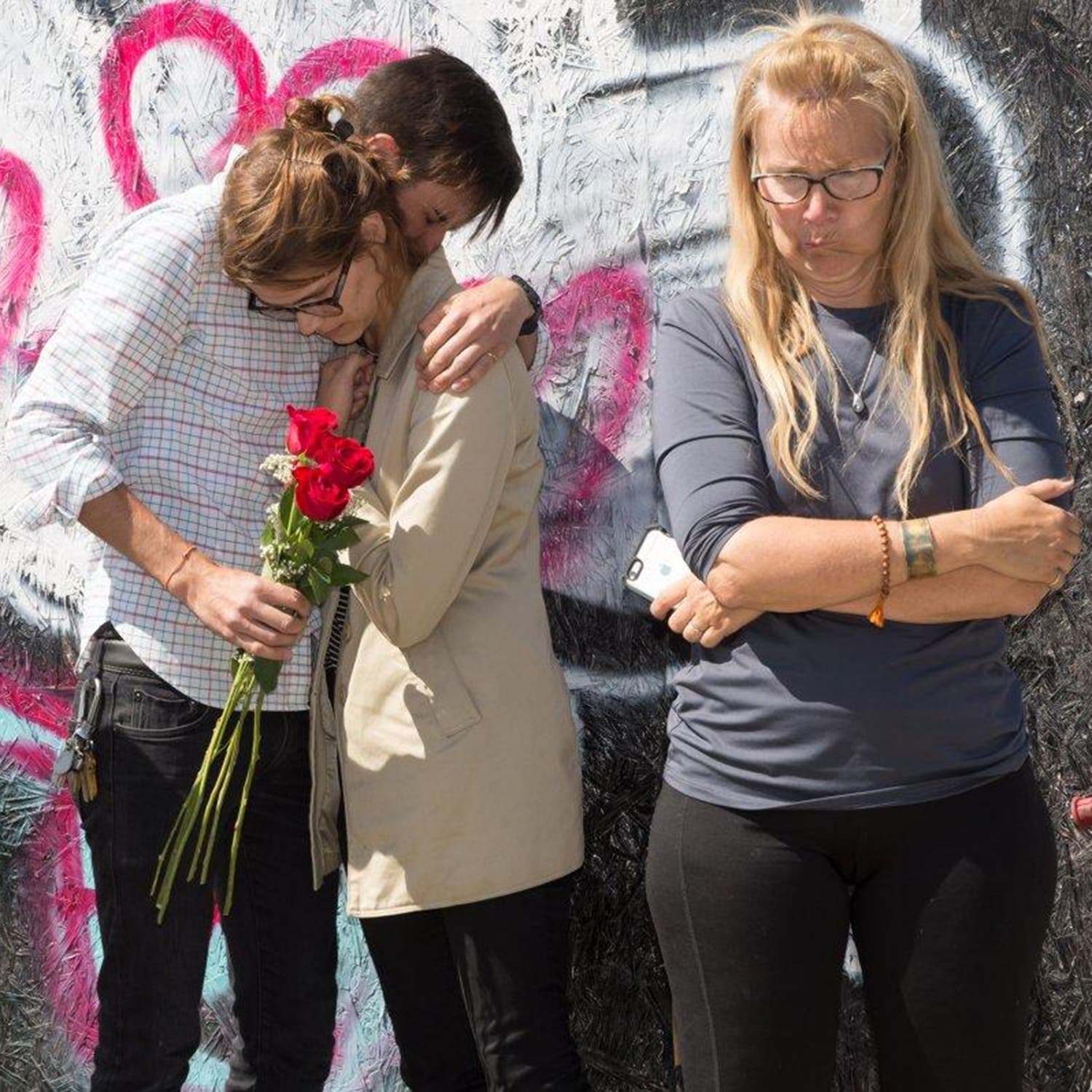 From left: Lauren’s partner, Danielle, and Lana next to a memorial set up for Lauren