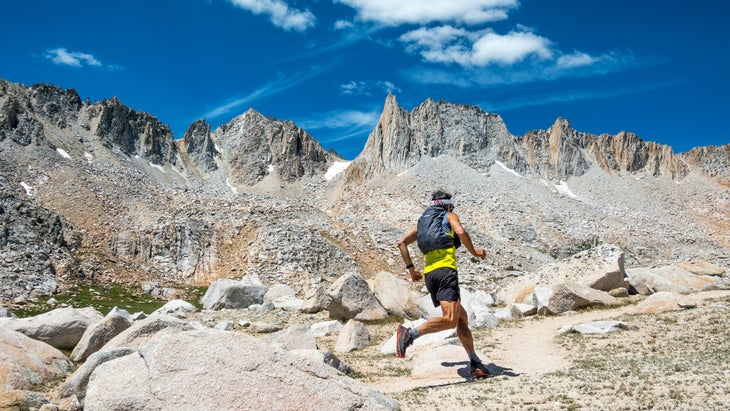 Runner in mountains wearing Patagonia Slope Runner Exploration Pack
