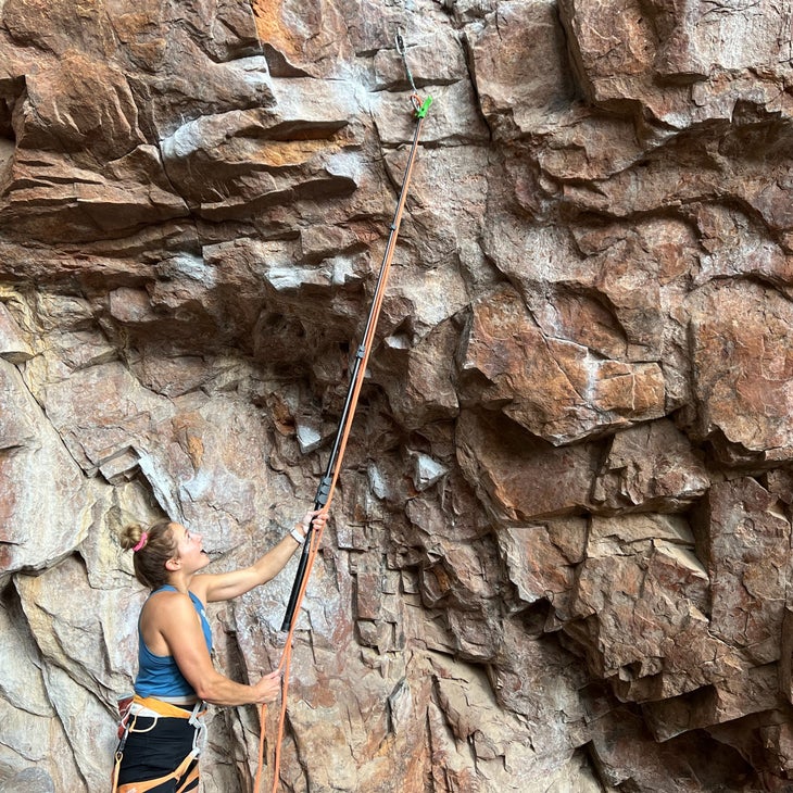 climber with stick clip for rope