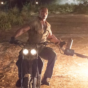 Man riding motorcycle with flame thrower