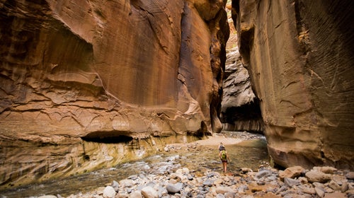 People hike in the Narrows, a popular slot canyon at at Utah’s Zion National Park.