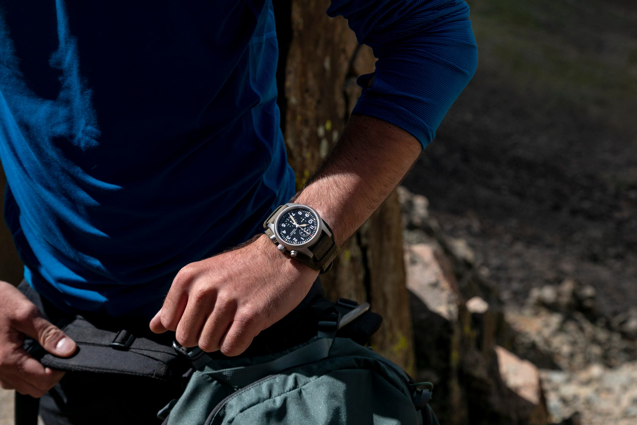 Climber checks the time on his watch