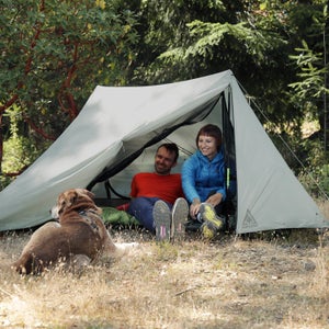 Two people sitting in an ultralight tent