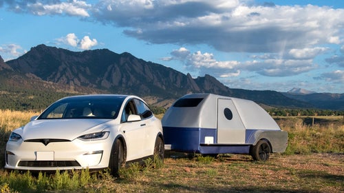 Electric trailer attached to a Tesla in the mountains