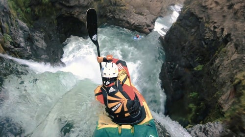 Man kayaks down a waterfall