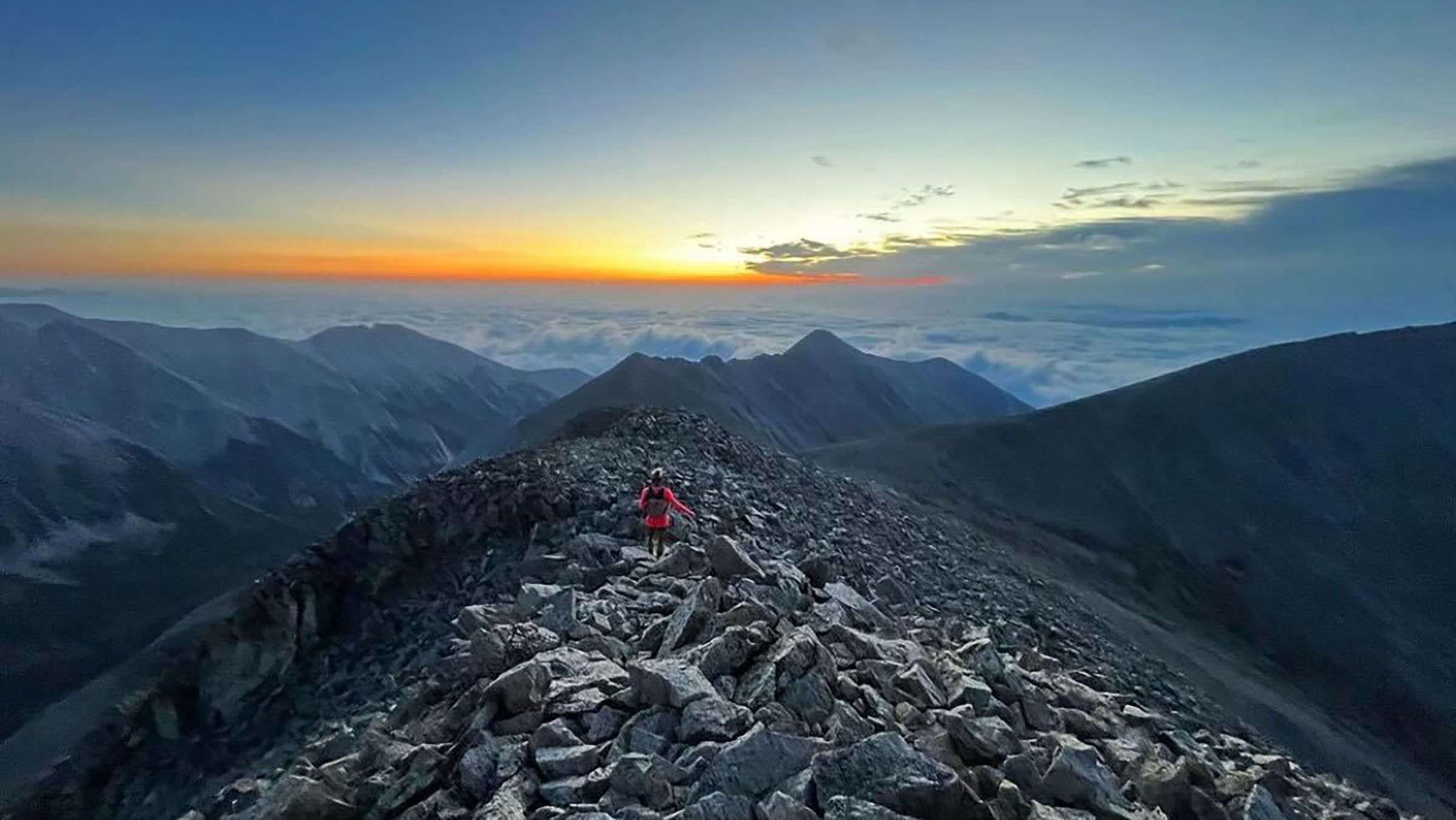 A hiker on a tall Colorado mountain