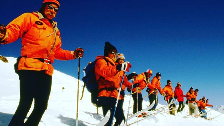 Ski patrol in a line on a mountain