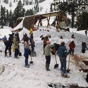 People searching through avalanche debris