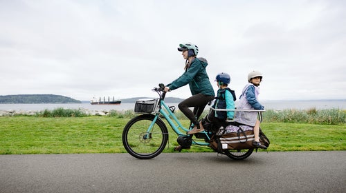 family biking on a large electric powered cargo bicycle