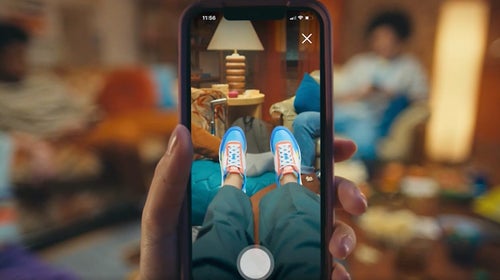 person looking at their feet through phone camera