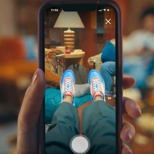 person looking at their feet through phone camera