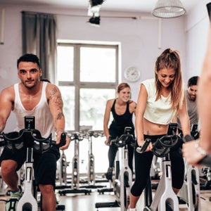 People work on during an indoor spin class