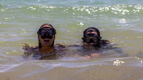 two women swimming in the ocean