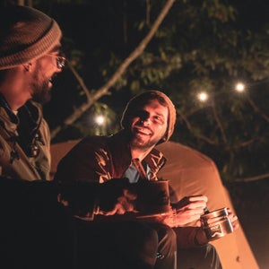 Two people with lights camping