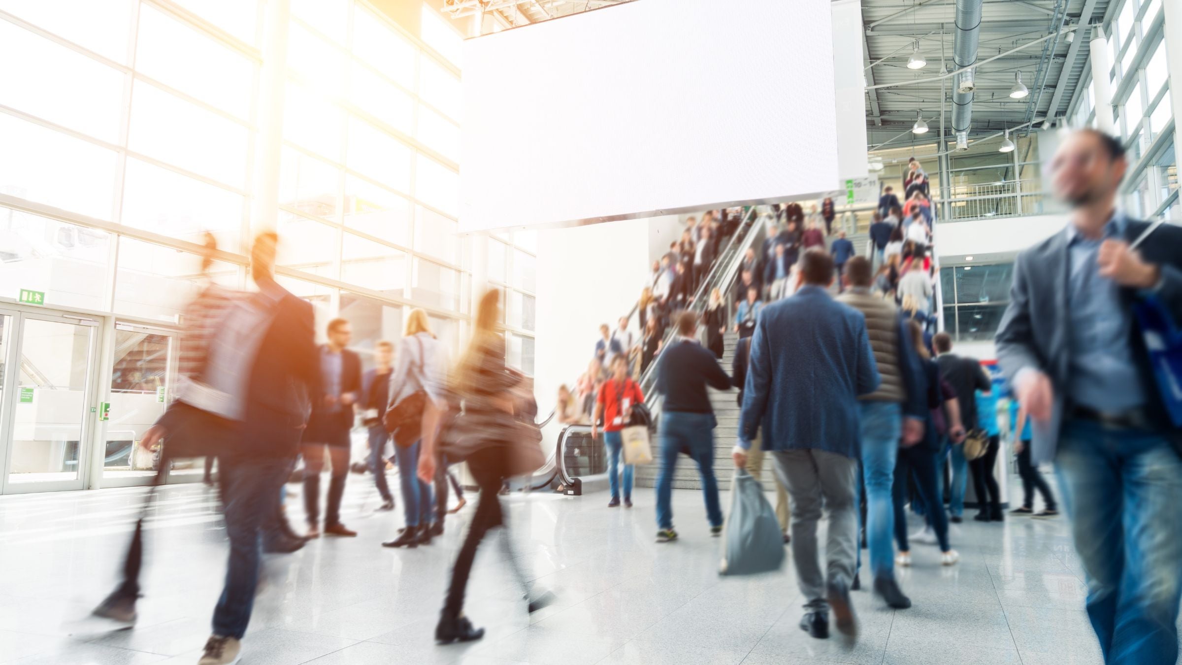 A crowd walking through a trade show