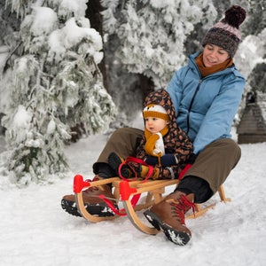Mother and toddler sledding