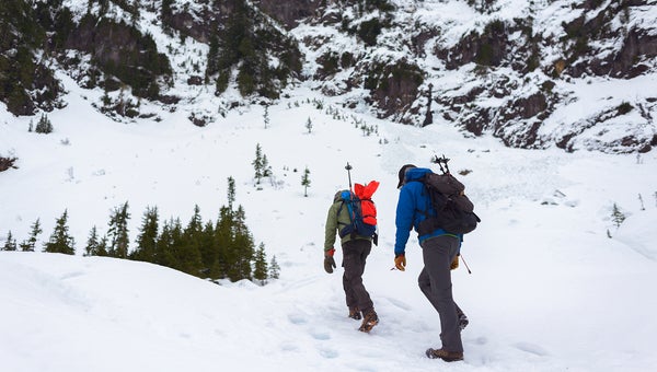 Two hikers walking through the snow