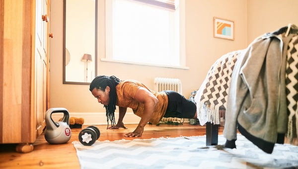 Shot of a muscular man doing push ups at home