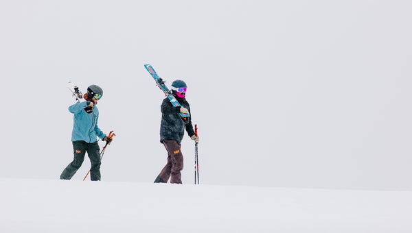 Skiers walking on snow