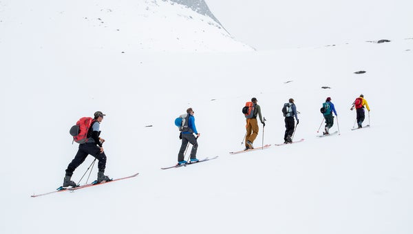 Skiers touring with packs