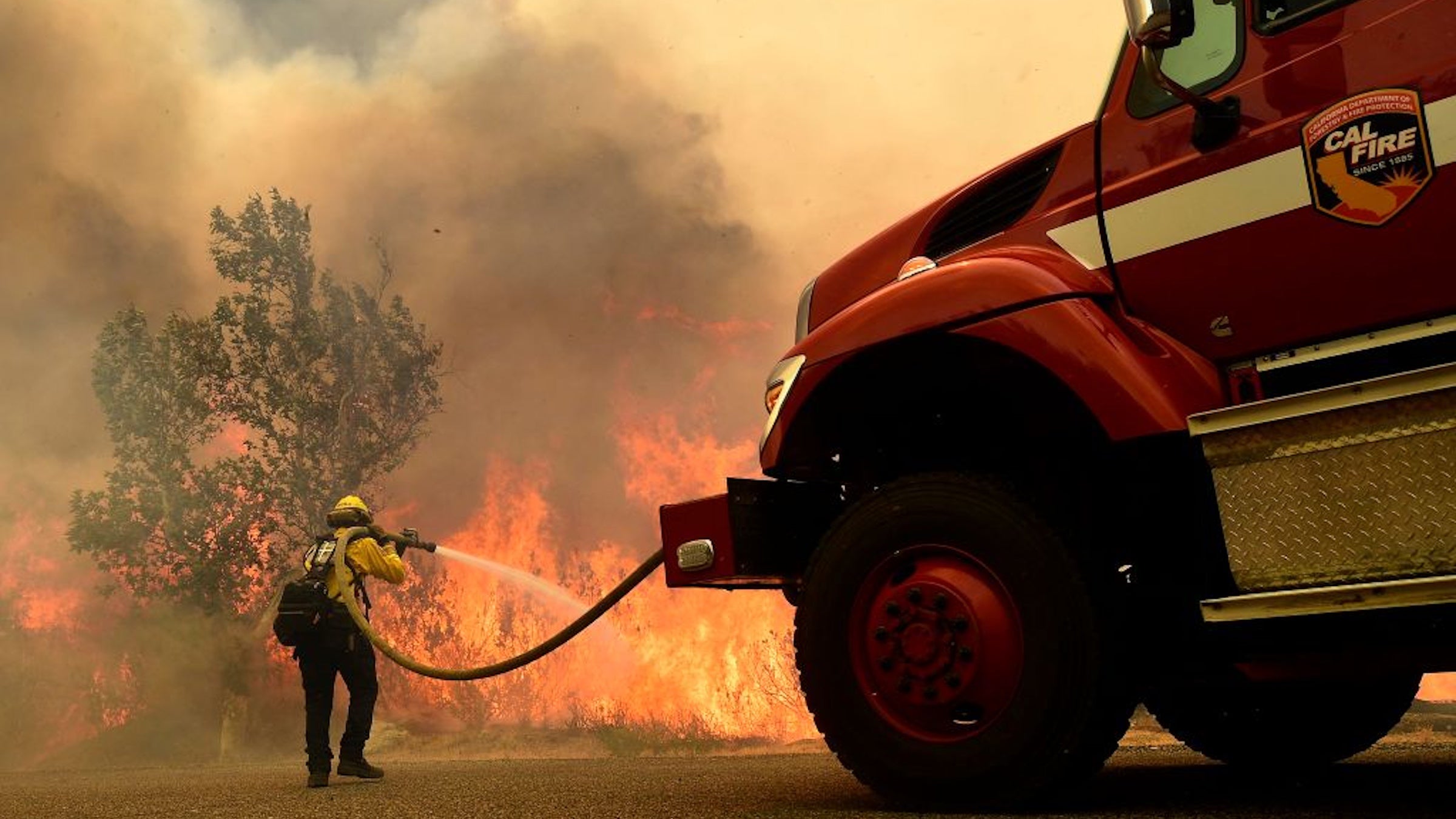 A Cal Fire firefighter works to keep flames from the Fairview fire from crossing Bautista Canyon Road within the San Bernardino National Forest in Hemet on Wednesday, Sept. 7, 2022