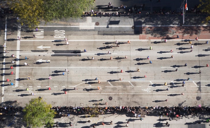 an aerial shot of a marathon moving right to left, with shadows