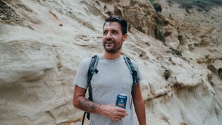 Man holding a drink from Athletic Brewing Company