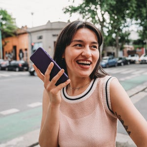 Woman records herself on her phone while walking outside