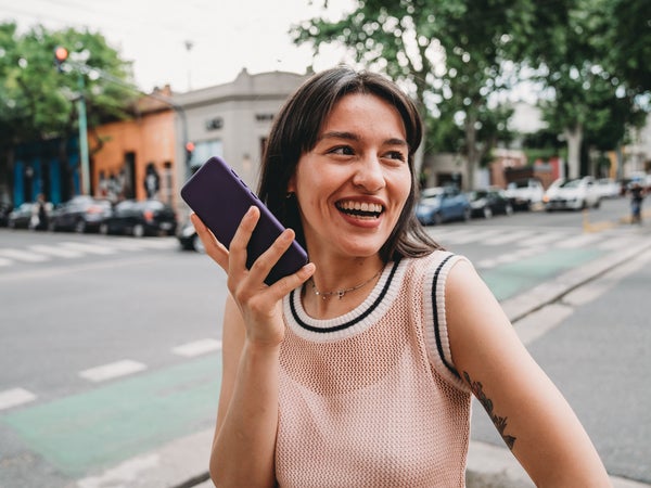 Woman records herself on her phone while walking outside