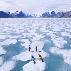 Two people skiing on frozen ice