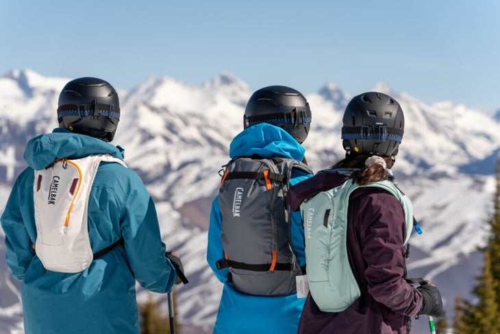 three skiers in CamelBak backpacks