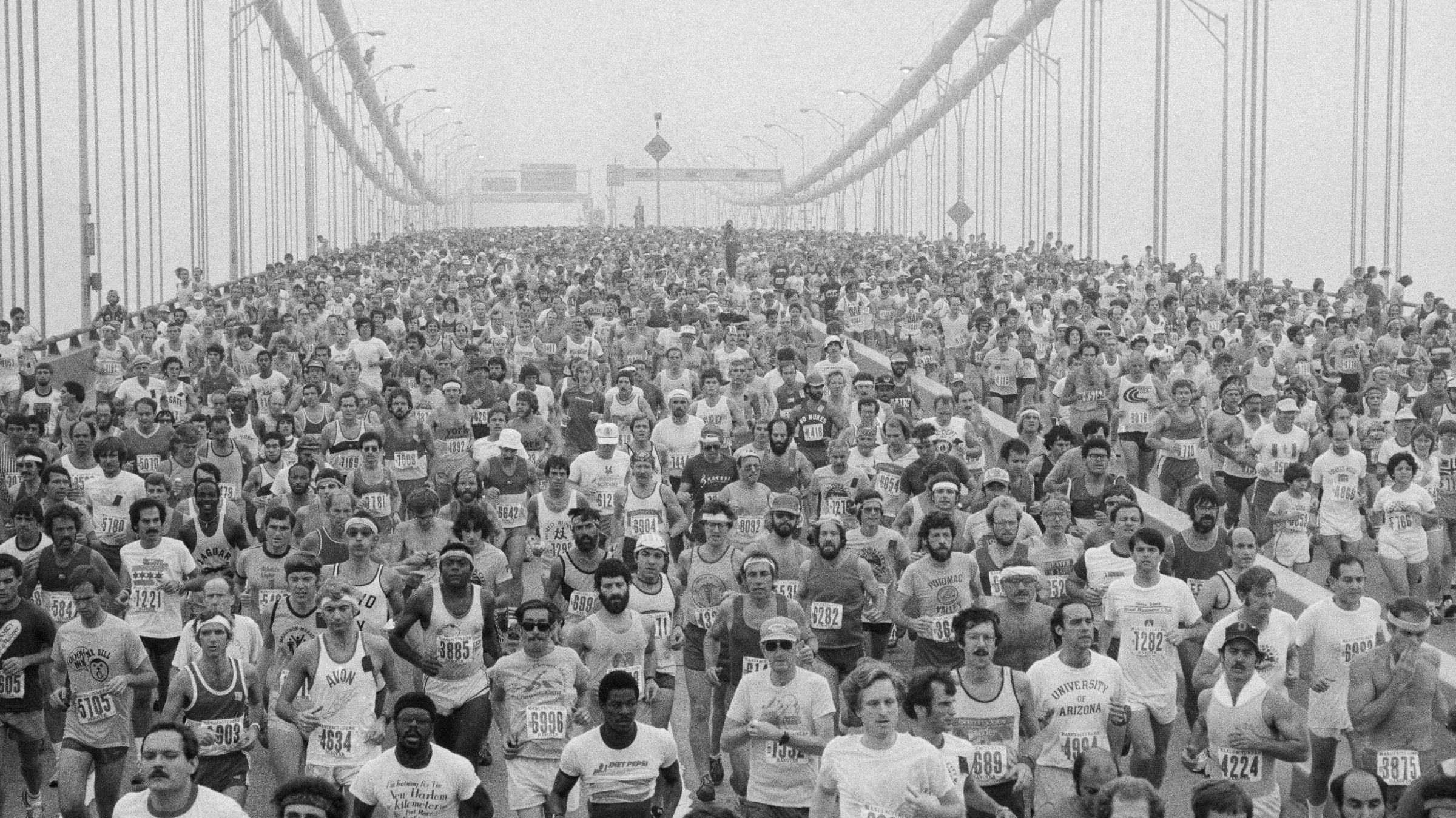 runners crossing a bridge at the New York City marathon