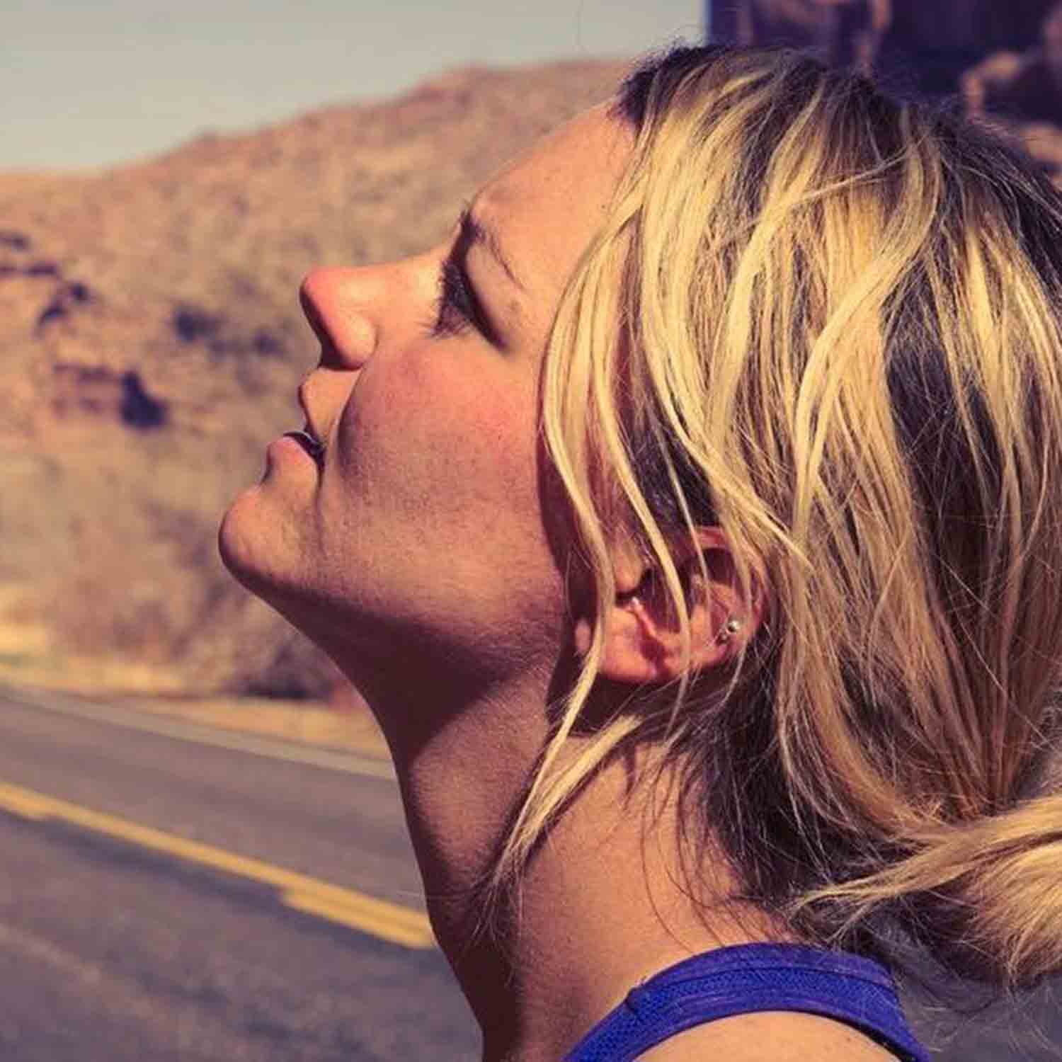 woman looking up at cliff