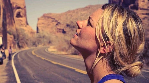 woman looking up at cliffs