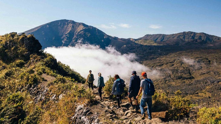 Five hikers walk the ridgeline of Maui’s Halemau'u Trail.