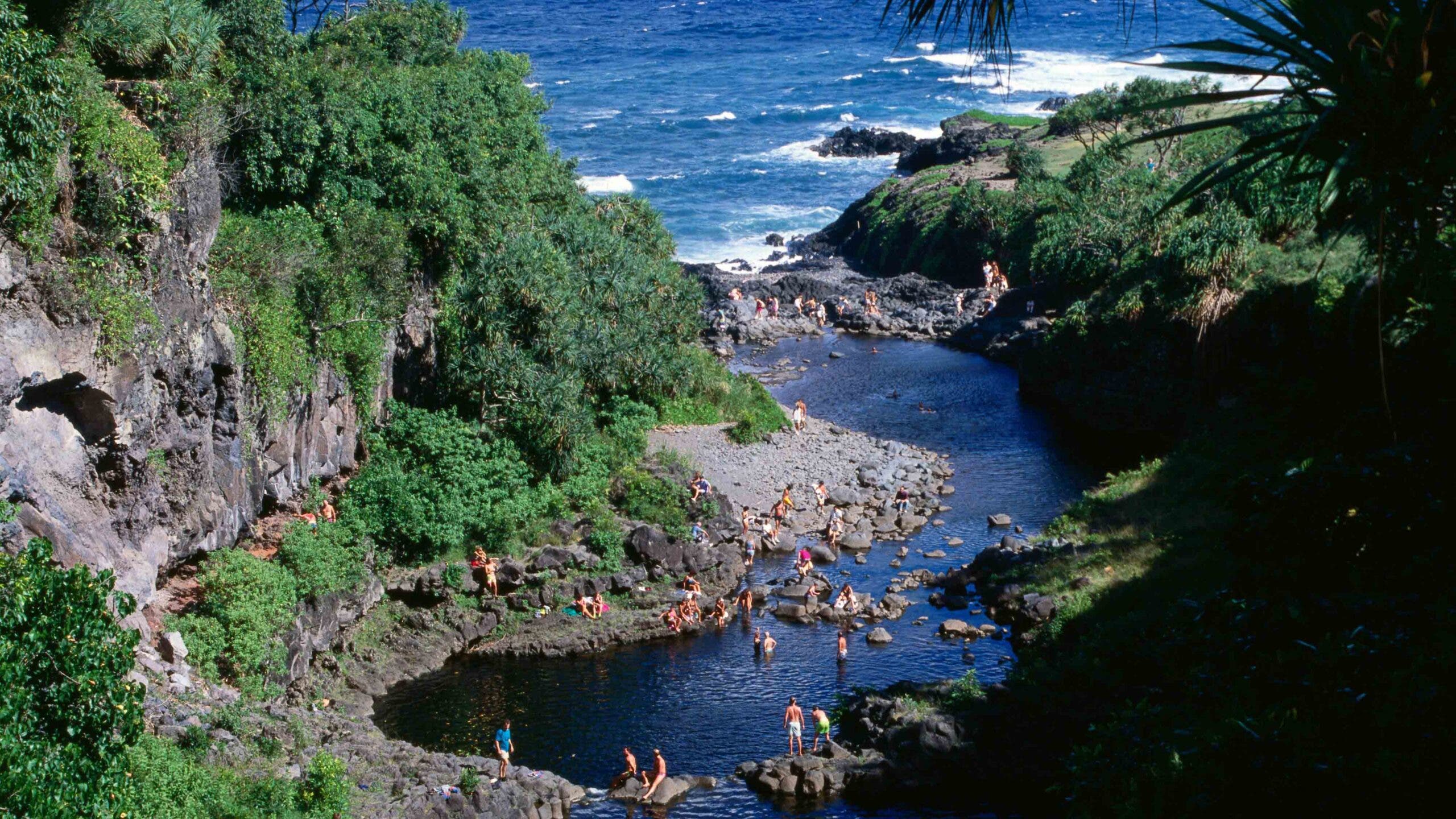 Dozens of swimmers wade into Maui’s Oheo Stream (Seven Pools), which flows into the Pacific.