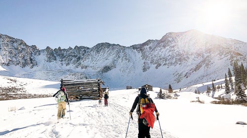 mountains skiers lodge