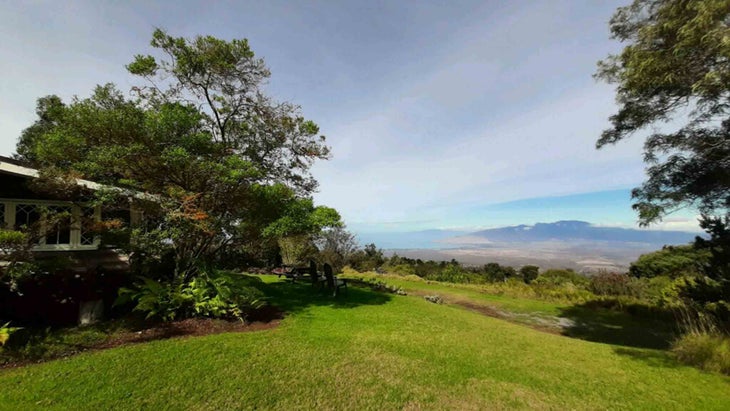 The yard and downvalley vistas from Malu Manu, a one-bedroom log cabin in Maui