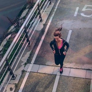 A woman running across a bridge as seen from above
