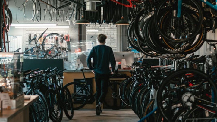 man walking through bike shop