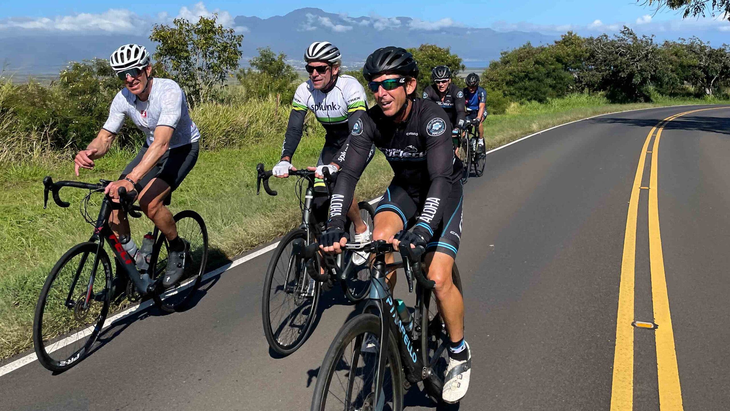 A group of road cyclists pedal around the island of Maui.