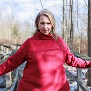 Kara Richardson Whitely standing on a wooden bridge in winter