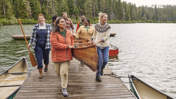People wearing L.L. Bean apparel carry a canoe