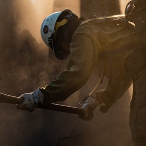 firefighter with backpack and axe