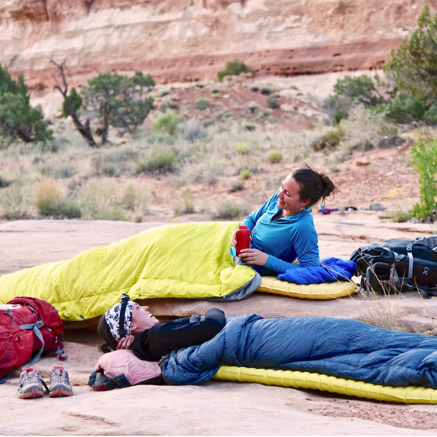 Two backpackers snuggling in for the night