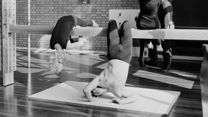 Vintage black and white photo of a gymnastics class using gym equipment