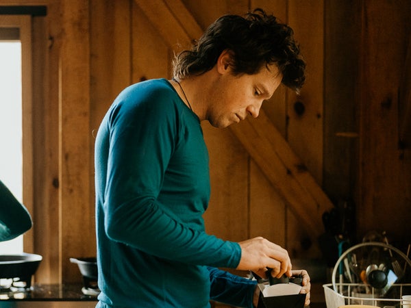 man making coffee wearing merino wool shirt