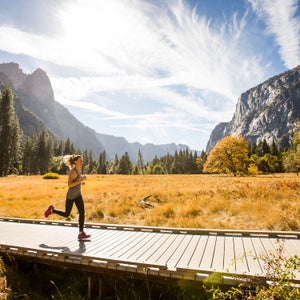 woman running meadow boardwalk