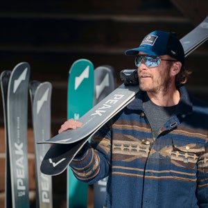 Bode Miller carrying a pair of Peak Skis