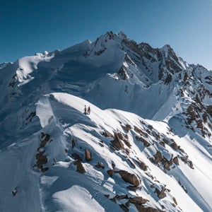 Skiers on a dramatic ridgeline